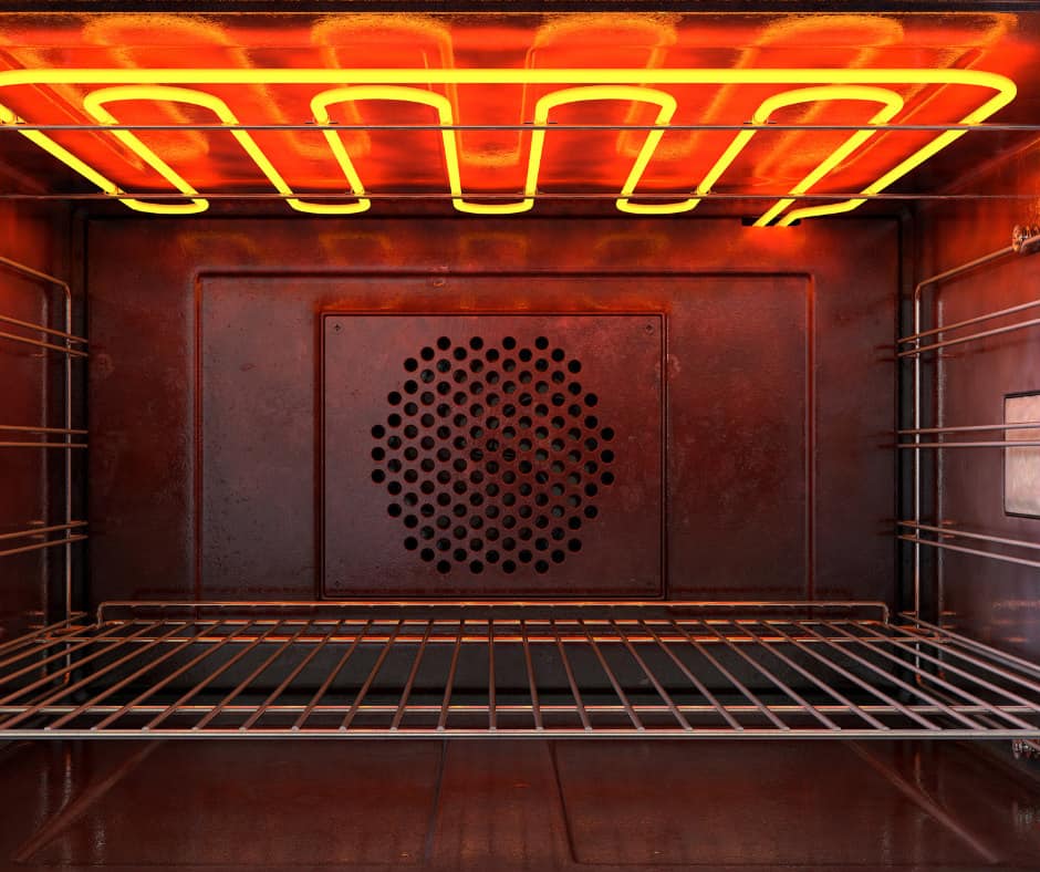 Close-up view of oven interior with heating element glowing, showing possible malfunction from inaccurate oven thermostat.